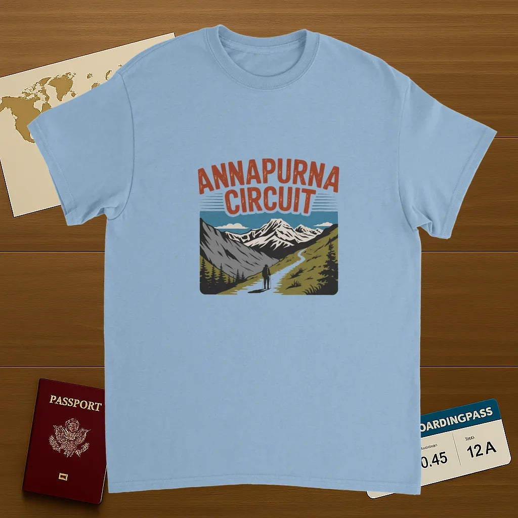 light blue Annapurna Circuit Nepal Unisex Travel T-Shirt on wooden background with world map, passport, and boarding pass