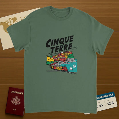 military green Cinque Terre Italy Unisex Travel T-Shirt on wooden background with world map, passport, and boarding pass