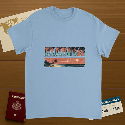 light blue Florida USA Unisex Travel T-Shirt on wooden background with world map, passport, and boarding pass