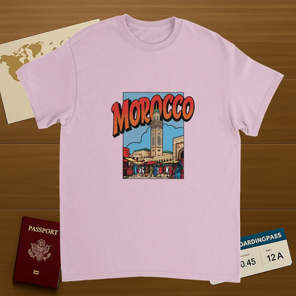 light pink Morocco Unisex Travel T-Shirt on wooden background with world map, passport, and boarding pass
