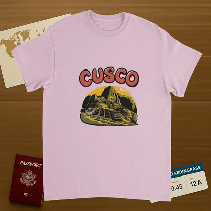 light pink Cusco Peru Unisex Travel T-Shirt on wooden background with world map, passport, and boarding pass