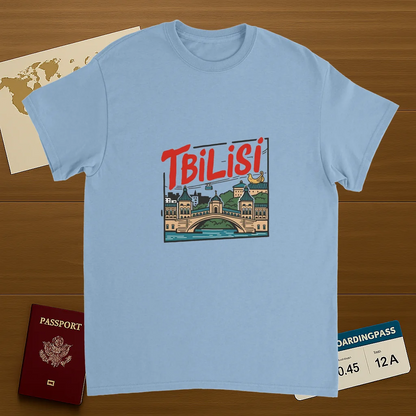 light blue Tbilisi Georgia Unisex Travel T-Shirt on wooden background with world map, passport, and boarding pass