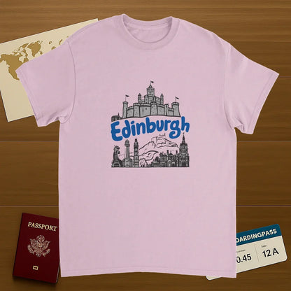light pink Edinburgh Scotland Unisex Travel T-Shirt on wooden background with world map, passport, and boarding pass