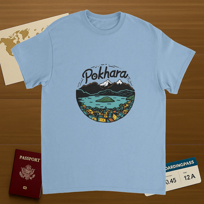 light blue Pokhara Nepal Unisex Travel T-Shirt on wooden background with world map, passport, and boarding pass