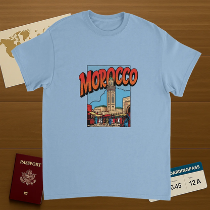 light blue Morocco Unisex Travel T-Shirt on wooden background with world map, passport, and boarding pass