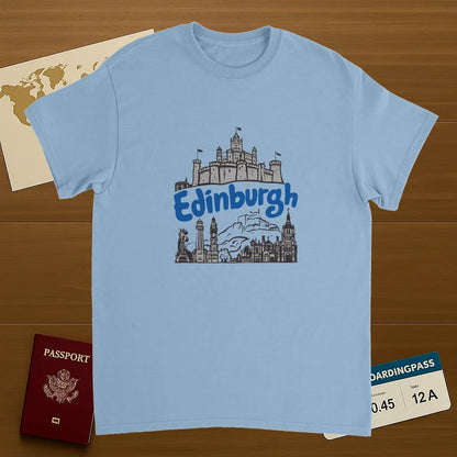 light blue Edinburgh Scotland Unisex Travel T-Shirt on wooden background with world map, passport, and boarding pass