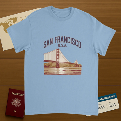 light blue San Francisco USA Unisex Travel T-Shirt on wooden background with world map, passport, and boarding pass