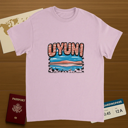 light pink Uyuni Bolivia Unisex Travel T-Shirt on wooden background with world map, passport, and boarding pass