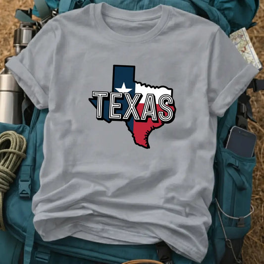 Gray t-shirt with Texas state outline design on a backpack and camping gear background