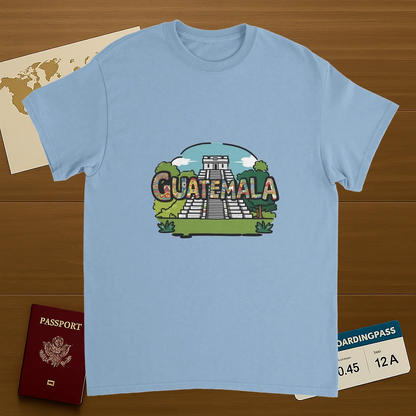 light blue Guatemala Unisex Travel T-Shirt on wooden background with world map, passport, and boarding pass