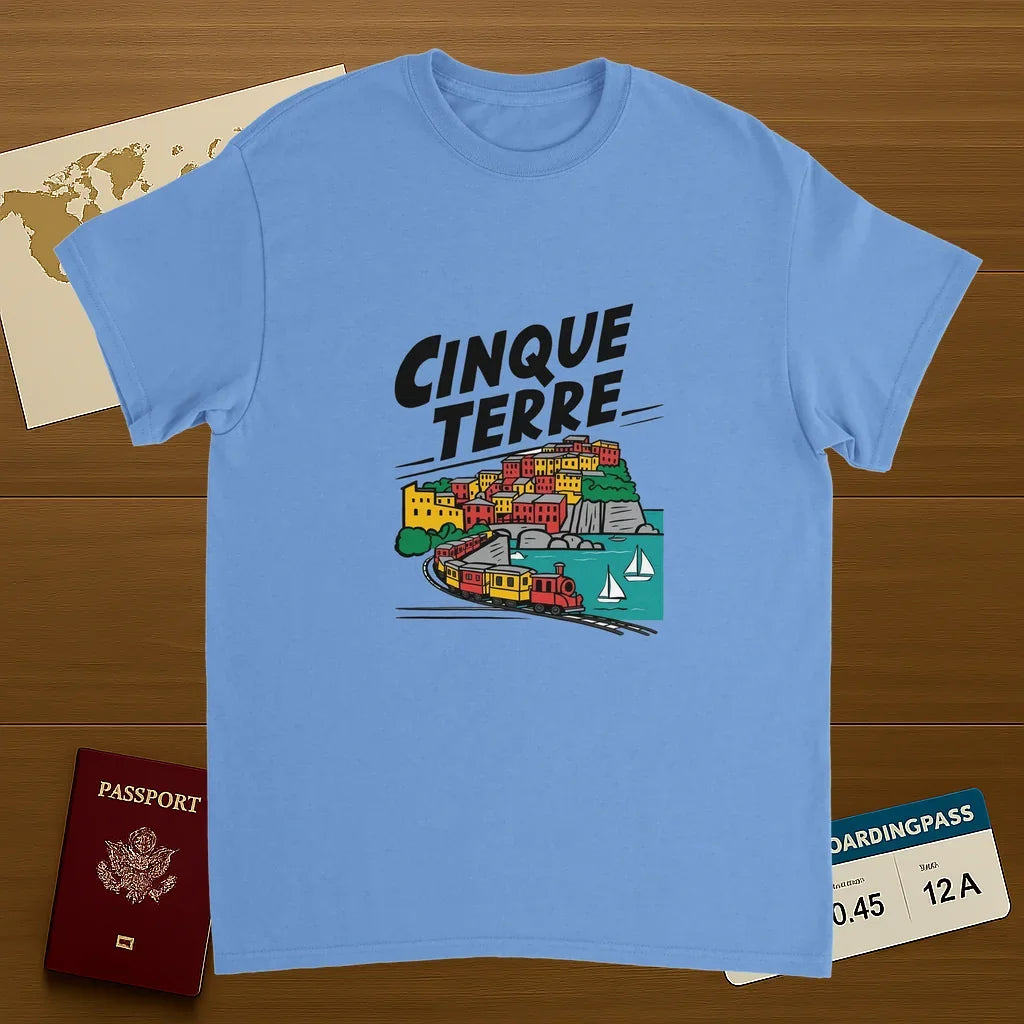 carolina blue Cinque Terre Italy Unisex Travel T-Shirt on wooden background with world map, passport, and boarding pass