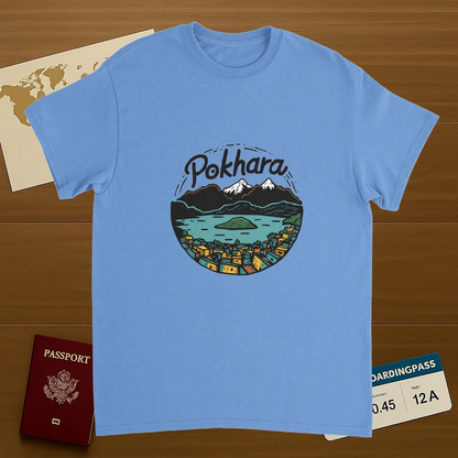 carolina blue Pokhara Nepal Unisex Travel T-Shirt on wooden background with world map, passport, and boarding pass