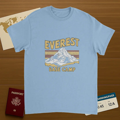 light blue Everest Base Camp Nepal Unisex Travel T-Shirt on wooden background with world map, passport, and boarding pass