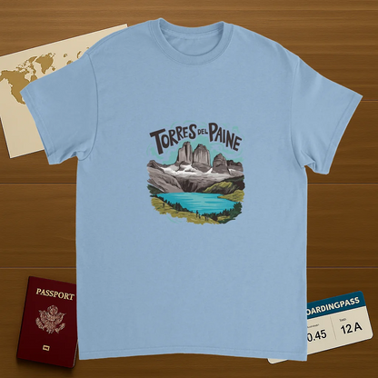 light blue Torres del Paine Chile Unisex Travel T-Shirt on wooden background with world map, passport, and boarding pass