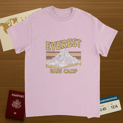 light pink Everest Base Camp Nepal Unisex Travel T-Shirt on wooden background with world map, passport, and boarding pass