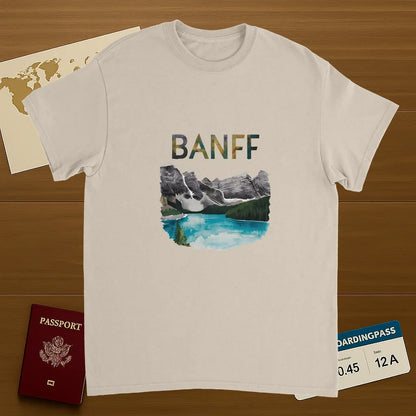 Banff Canada Unisex Travel T-Shirt on wooden background with world map, passport, and boarding pass