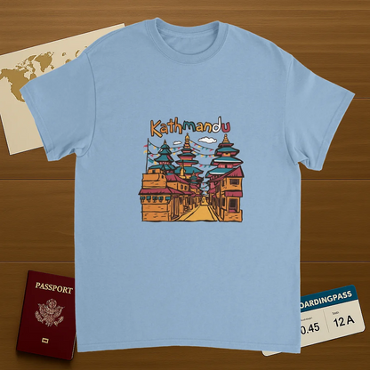 light blue Kathmandu Nepal Unisex Travel T-Shirt on wooden background with world map, passport, and boarding pass