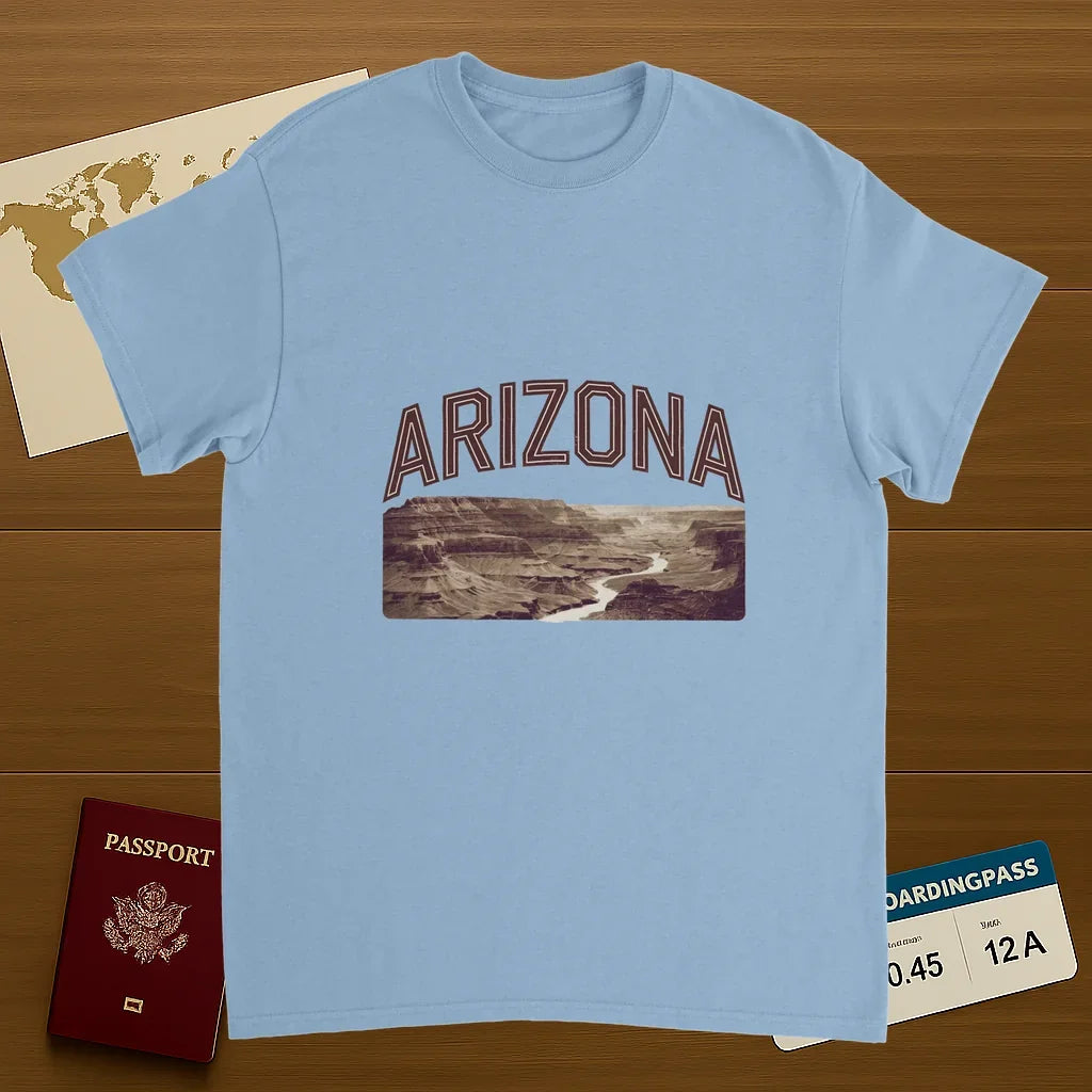 light blue Arizona USA Unisex Travel T-Shirt on wooden background with world map, passport, and boarding pass