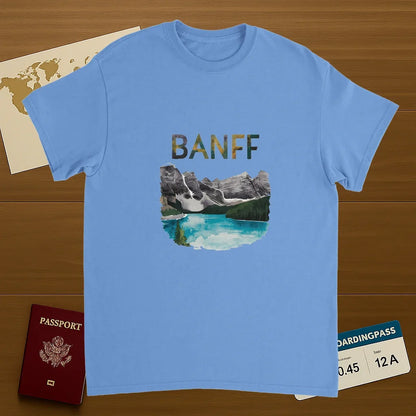 carolina blue Banff Canada Unisex Travel T-Shirt on wooden background with world map, passport, and boarding pass