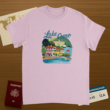 light pink Lake Como Italy Unisex Travel T-Shirt on wooden background with world map, passport, and boarding pass