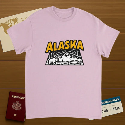 light pink Alaska USA Unisex Travel T-Shirt on wooden background with world map, passport, and boarding pass