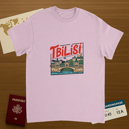light pink Tbilisi Georgia Unisex Travel T-Shirt on wooden background with world map, passport, and boarding pass